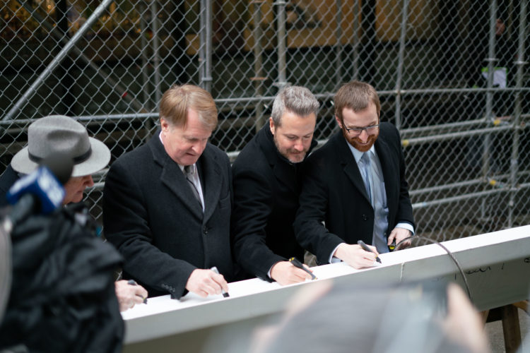 Rich Fitzgerald, Lucas Piatt and others sign beam at raising ceremony